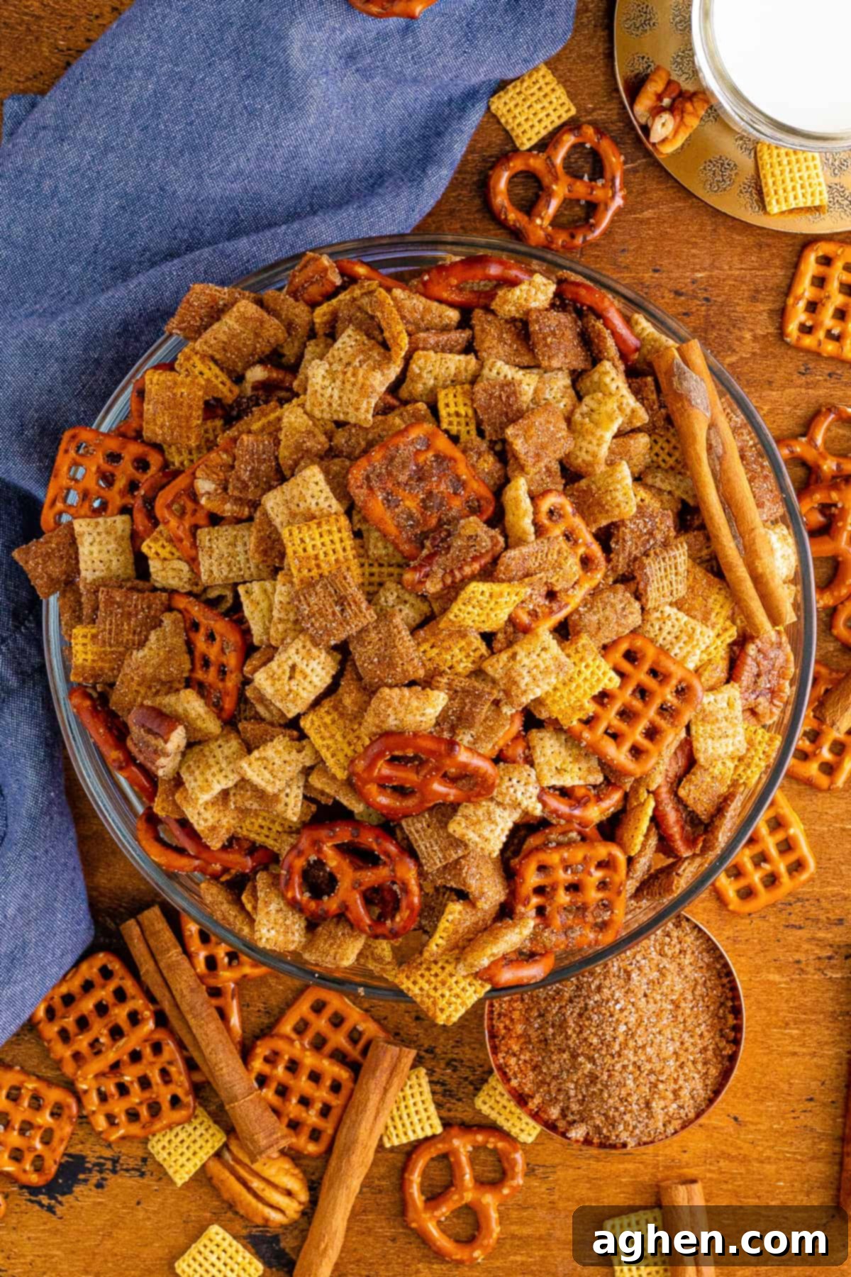 An overhead shot of Cinnamon and Sugar Chex Mix in a glass bowl, showcasing its crunchy texture and even coating.