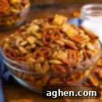Cinnamon sugar chex mix in glass serving bowl with measuring cup of brown sugar and cinnamon sticks beside it.d