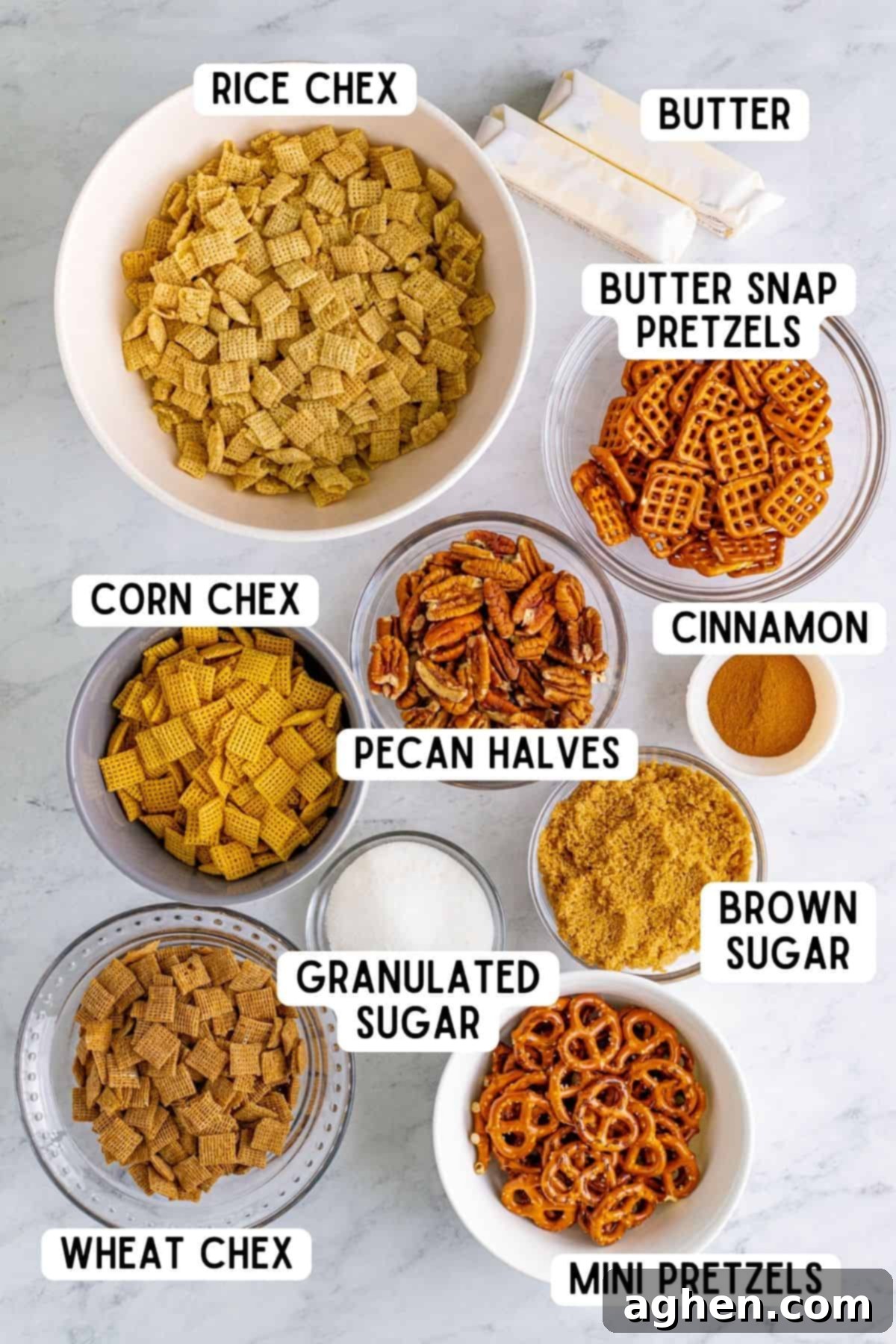 Neatly arranged ingredients for Cinnamon Sugar Chex Mix, including various Chex cereals, pretzels, pecans, butter, and sugars.
