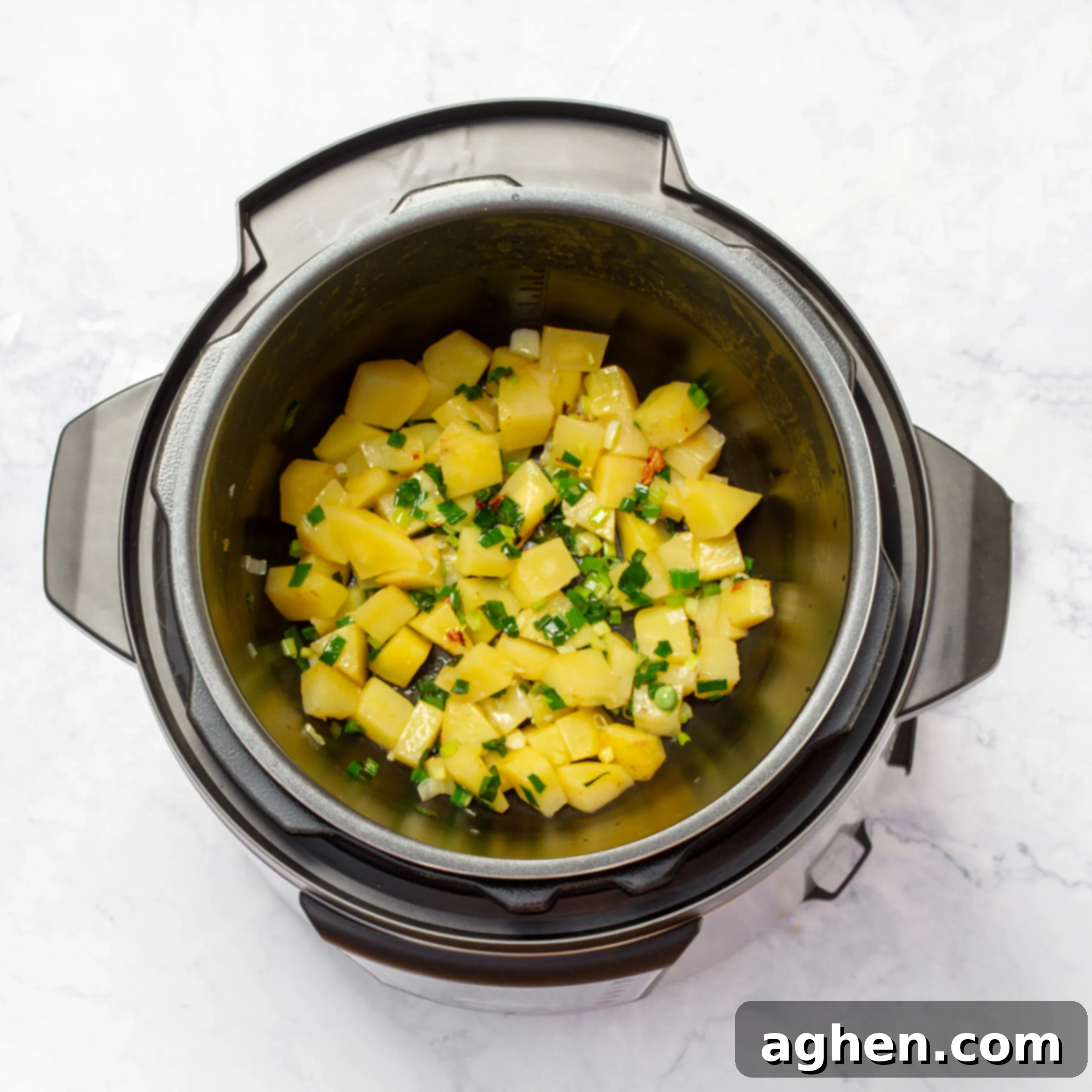 Minestrone's Spring Awakening: A Fresh Spin on the Classic 3 Aromatics and potatoes sautéing in the pressure cooker pot, showing the initial stages of building flavor for the soup.
