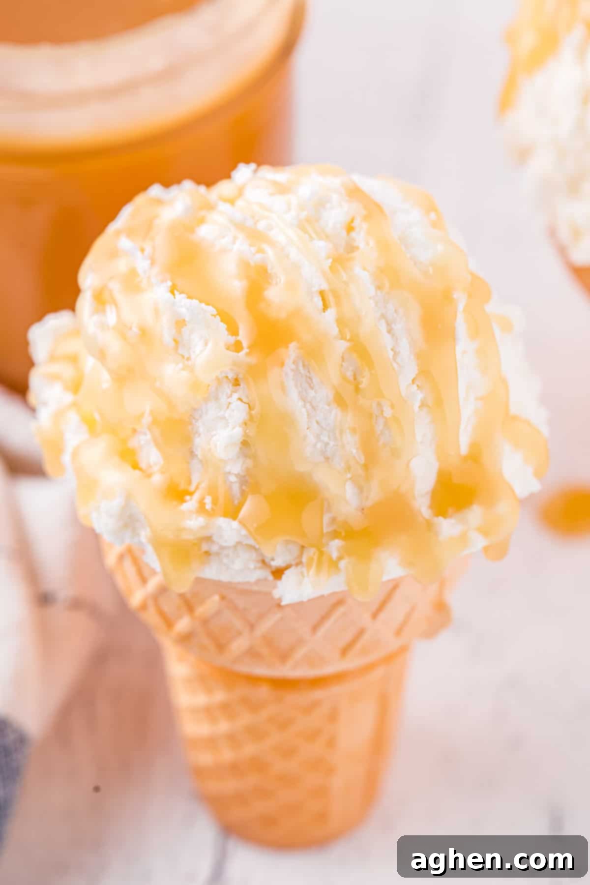 Perfect Homemade Caramel 10 Vanilla ice cream cone drizzled with caramel.