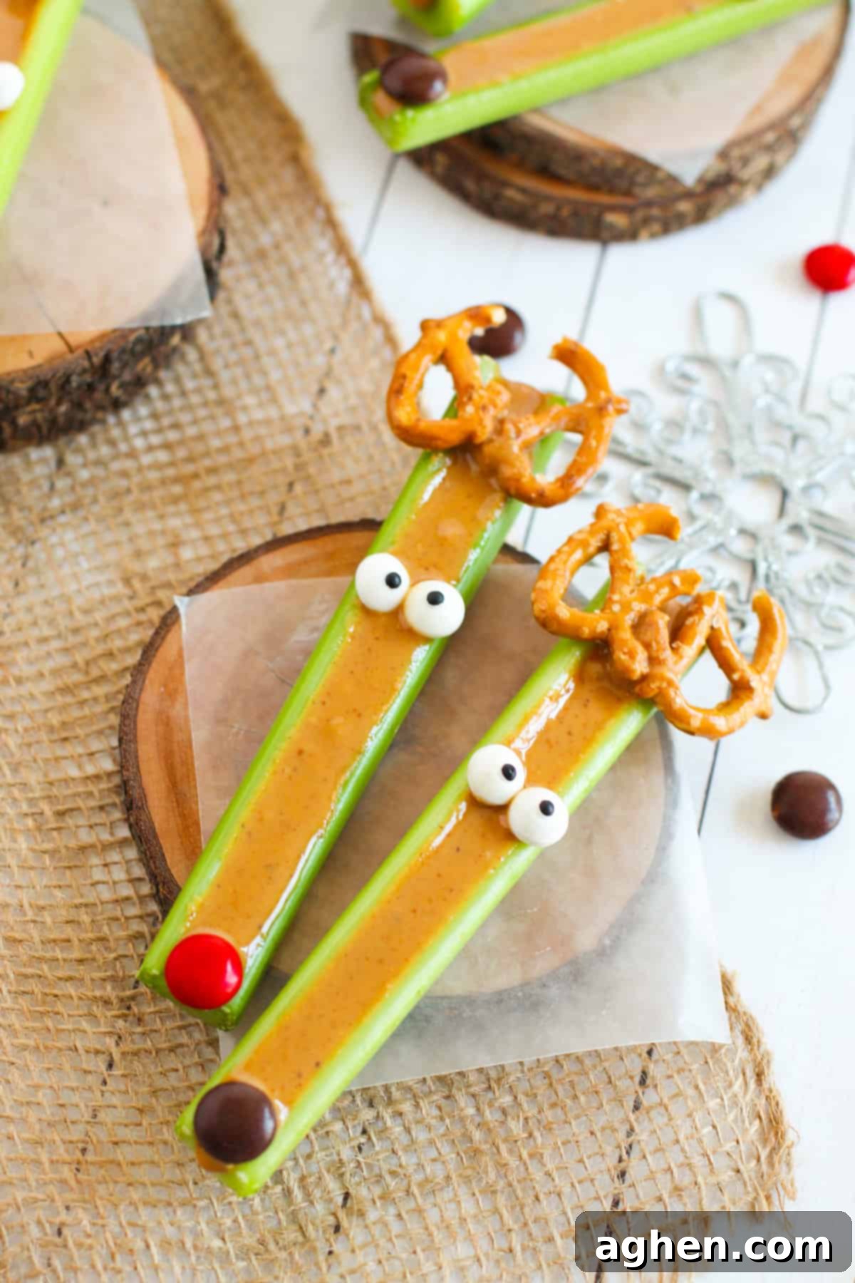 Festive Peanut Butter Antler Crunch 9 Two reindeer celery sticks, one with red nose like Rudolph and one with a brown nose.