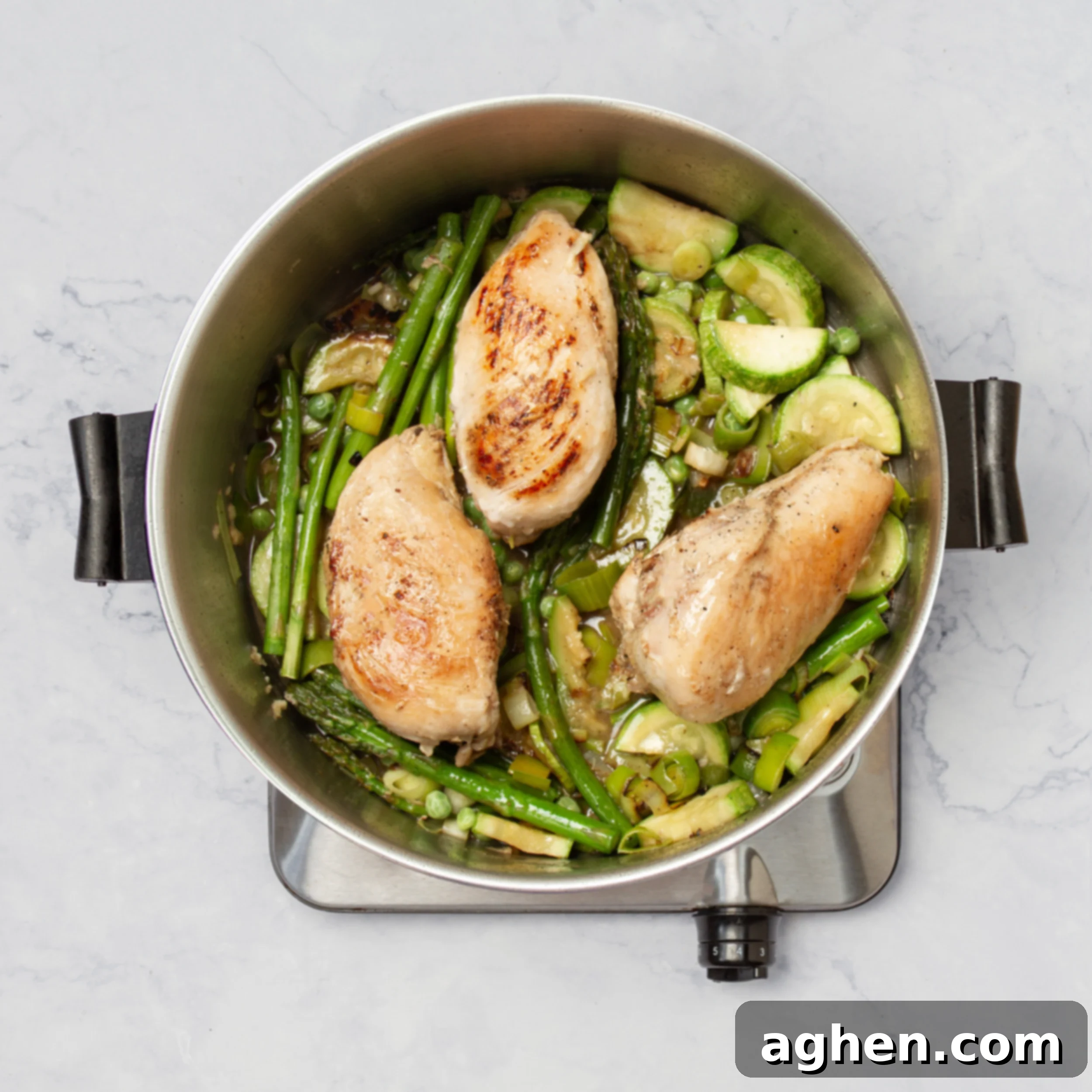 Weight Watchers' Iconic Chicken Primavera 6 Sliced zucchini, asparagus spears, and leeks added to the pan with the cooking chicken breasts, creating a colorful mix.