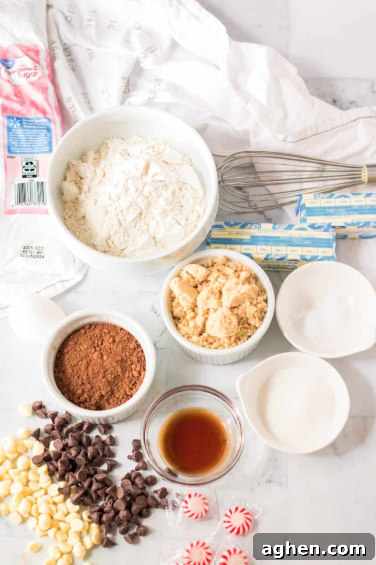 Arrangement of all necessary ingredients for baking chocolate peppermint bark cookies, neatly displayed on a countertop.