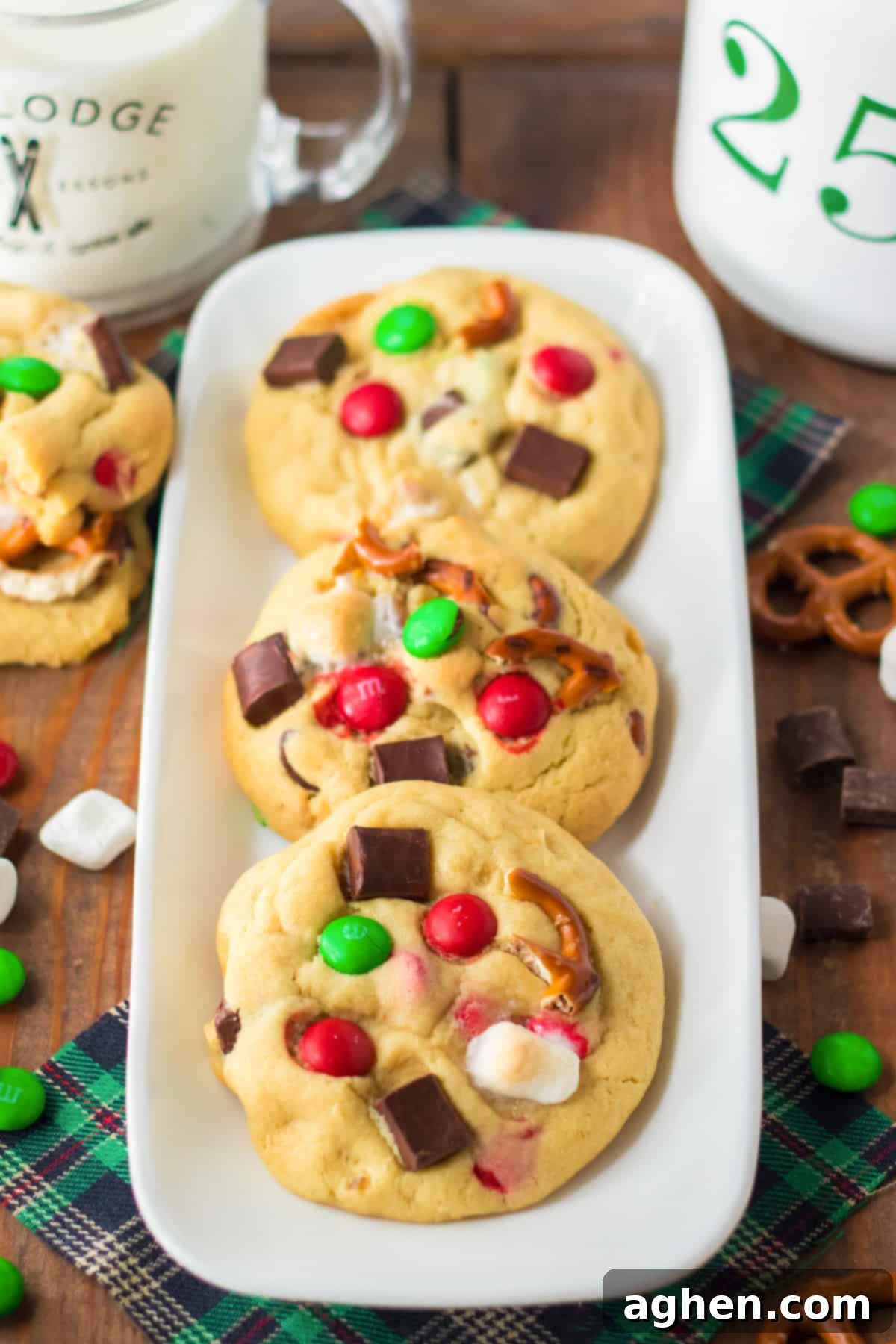 Vibrantly decorated Christmas kitchen sink cookies, adorned with crunchy pretzel pieces, festive green and red M&Ms, fluffy mini marshmallows, and rich chocolate chunks, perfect for holiday baking.