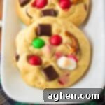 Kitchen sink cookies with Christmas M&Ms, mini marshmallows, pretzel pieces, and chocolate chunks.