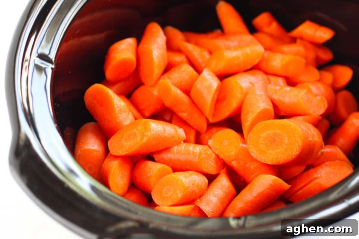 Raw chopped carrots in crockpot.