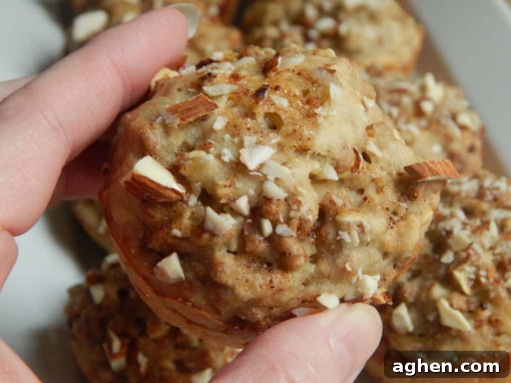 A tray of freshly baked, golden brown banana bran muffins, hot from the oven.