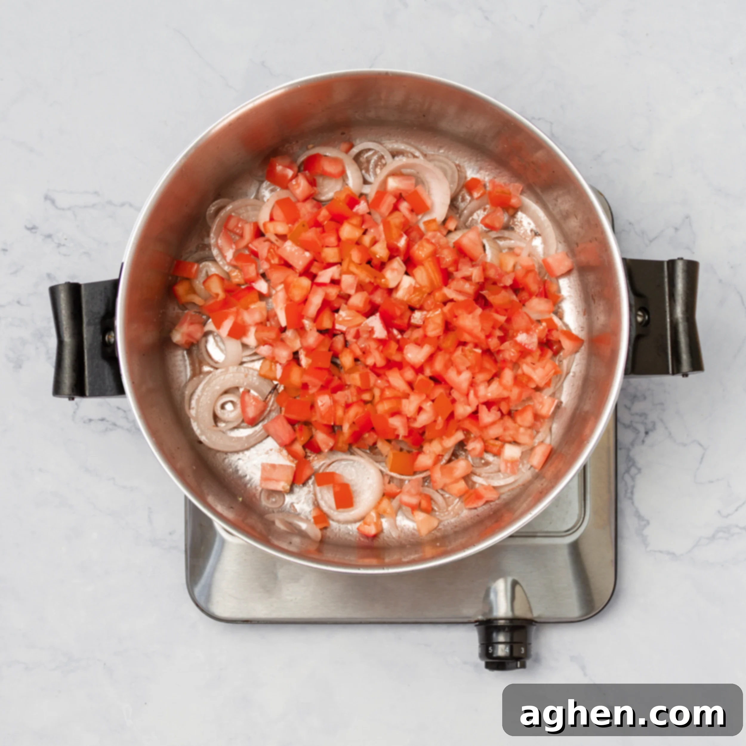 Sliced onions and diced tomatoes sautéing in the same pot after the beef has been seared, building the flavor base for the Swiss Steak sauce.