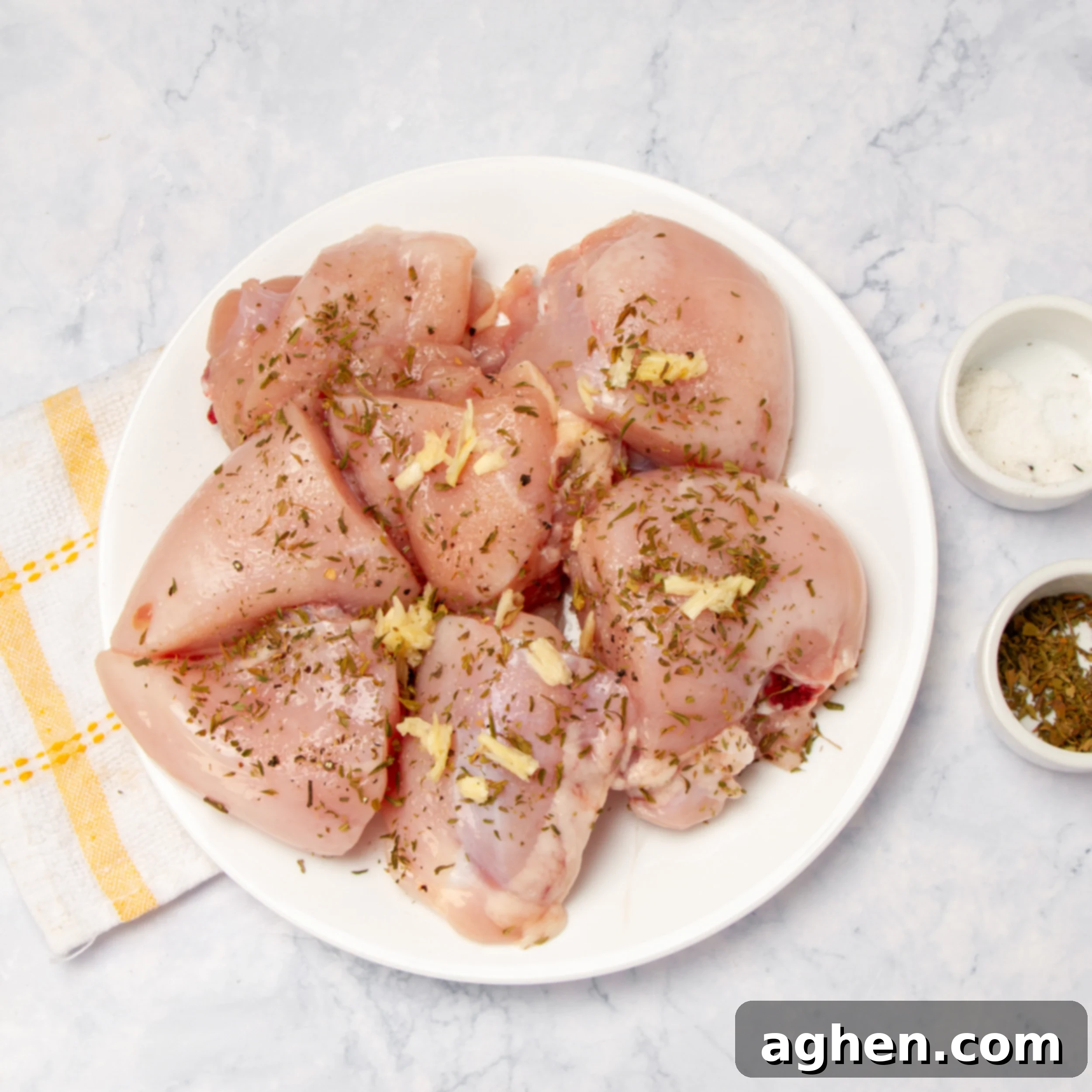 Weight Watchers' Favorite Chicken Caprese 4 Chicken breasts on a plate with seasonings on top.