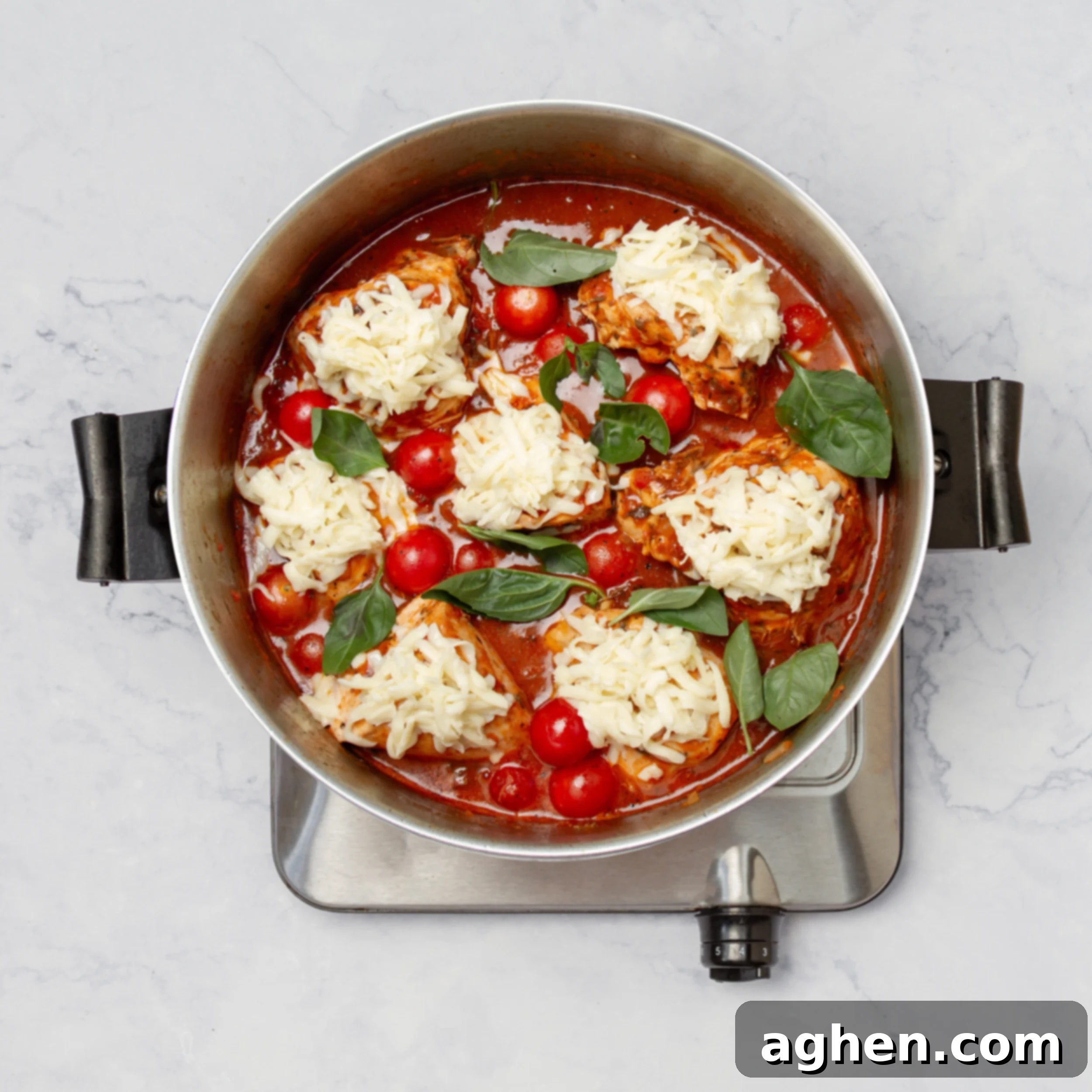 Weight Watchers' Favorite Chicken Caprese 7 Cooked chicken in the pan with sauce, topped with cheese, tomatoes, and fresh basil.