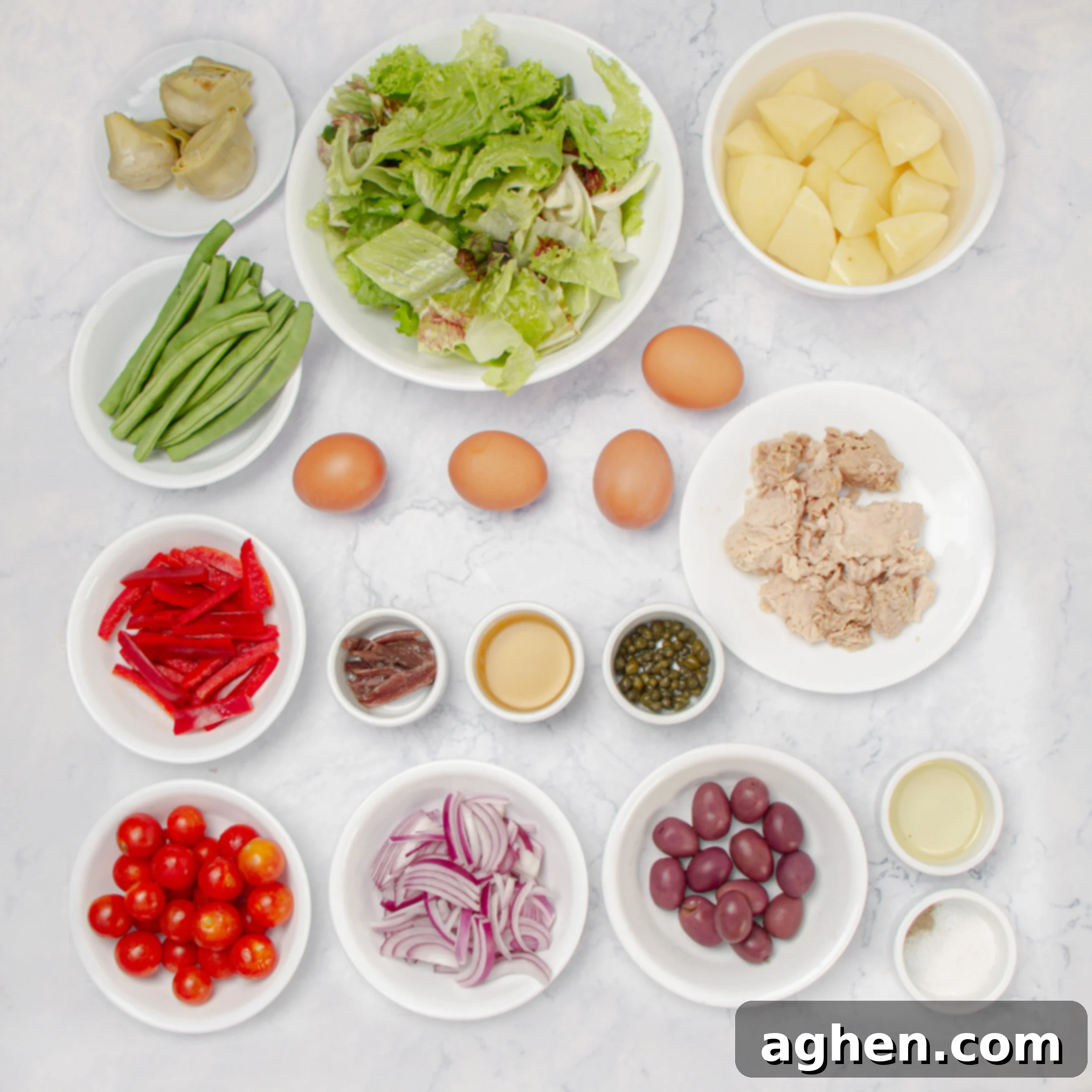 Niçoise Salad ingredients in separate dishes.