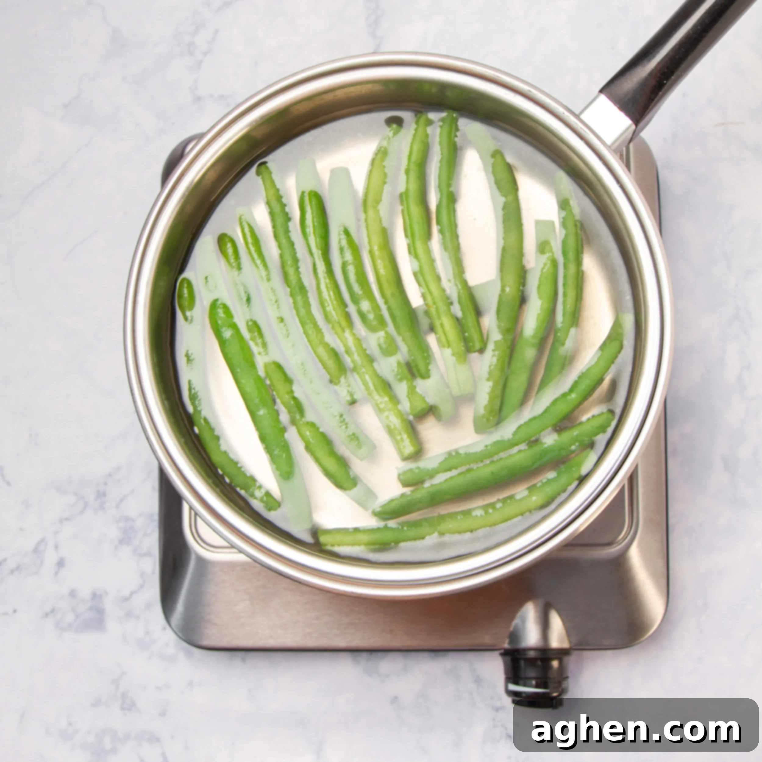Green beans blanching in a pot.