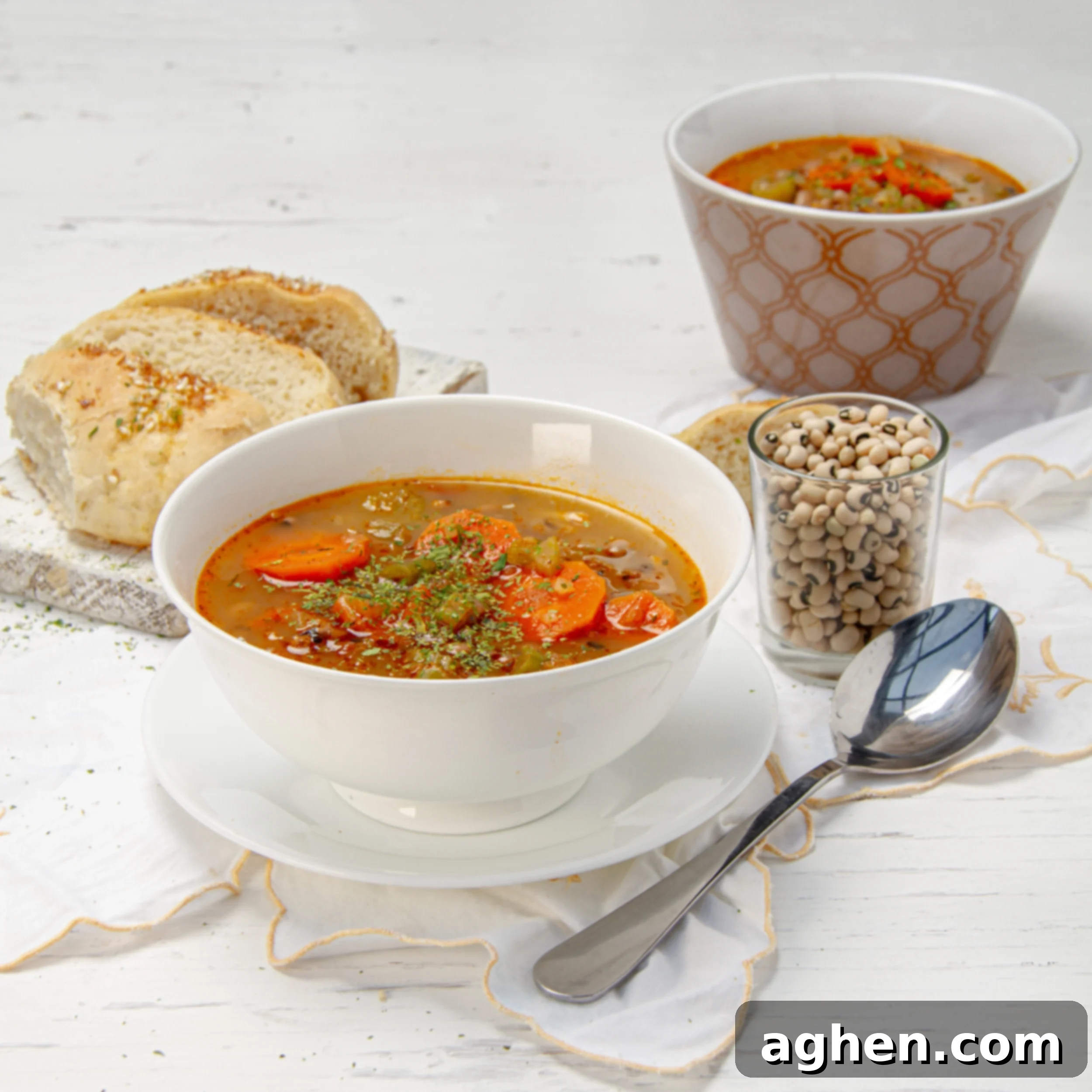 Hearty Black Eyed Pea Delight 2 Savory and satisfying Black Eyed Pea Soup in a bowl with a spoon and bread on the side.