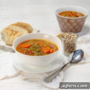 Hearty Black Eyed Pea Delight 7 Savory and satisfying Black Eyed Pea Soup in a bowl with a spoon and bread on the side.