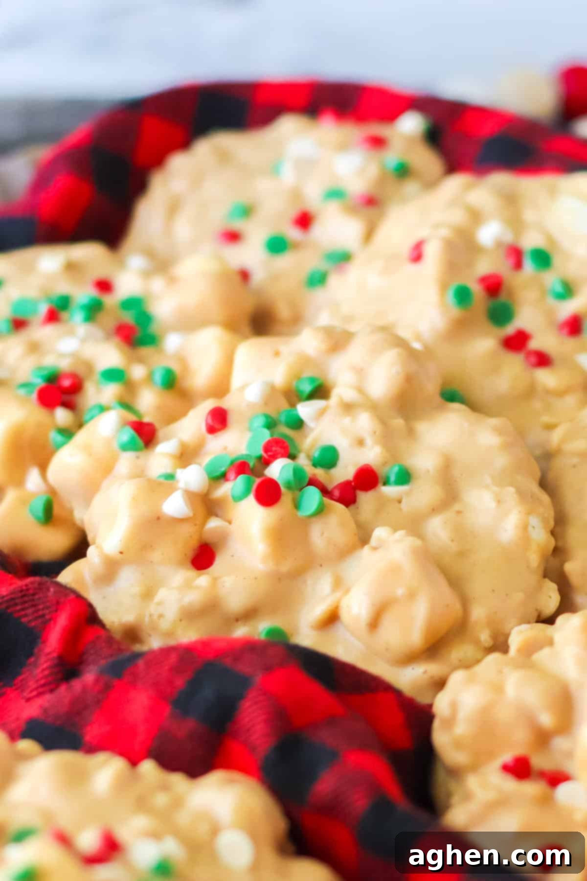 Close up of crockpot avalanche cookies with christmas sprinkles on buffalo plaid napkin.