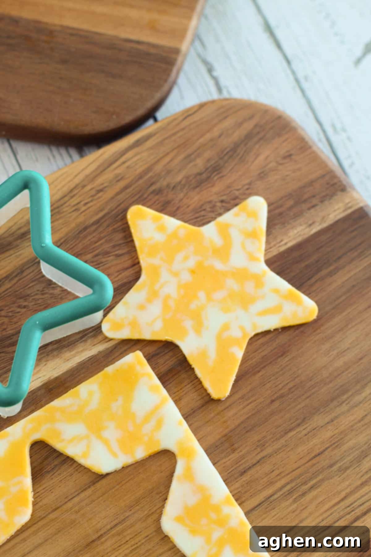 A star shape carefully cut out of a slice of cheese using a cookie cutter, ready to be placed on the charcuterie board.