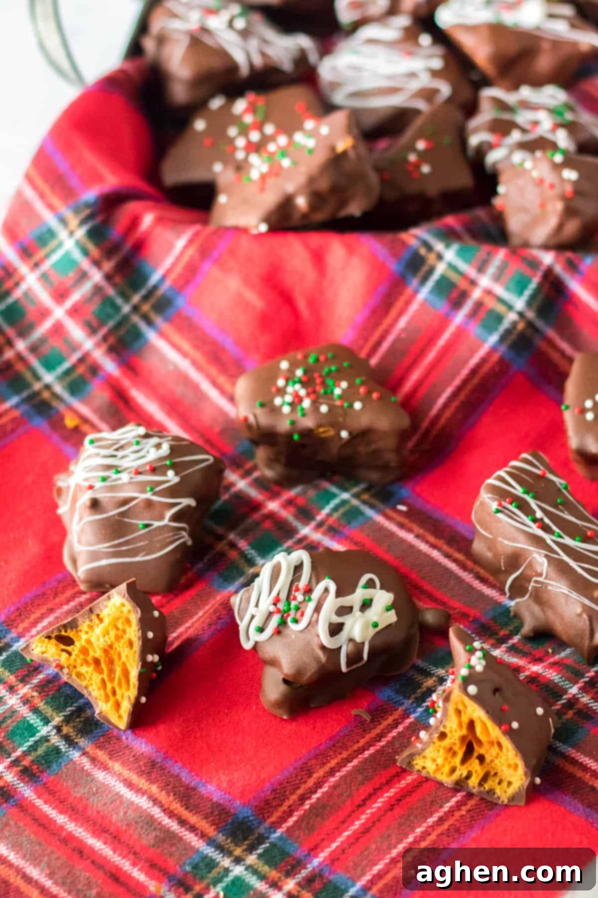 Honeycomb candy coated in chocolate on holiday linen.