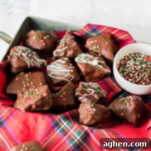 Honeycomb candy coated in chocolate and topped with white chocolate drizzle and Christmas sprinkles.