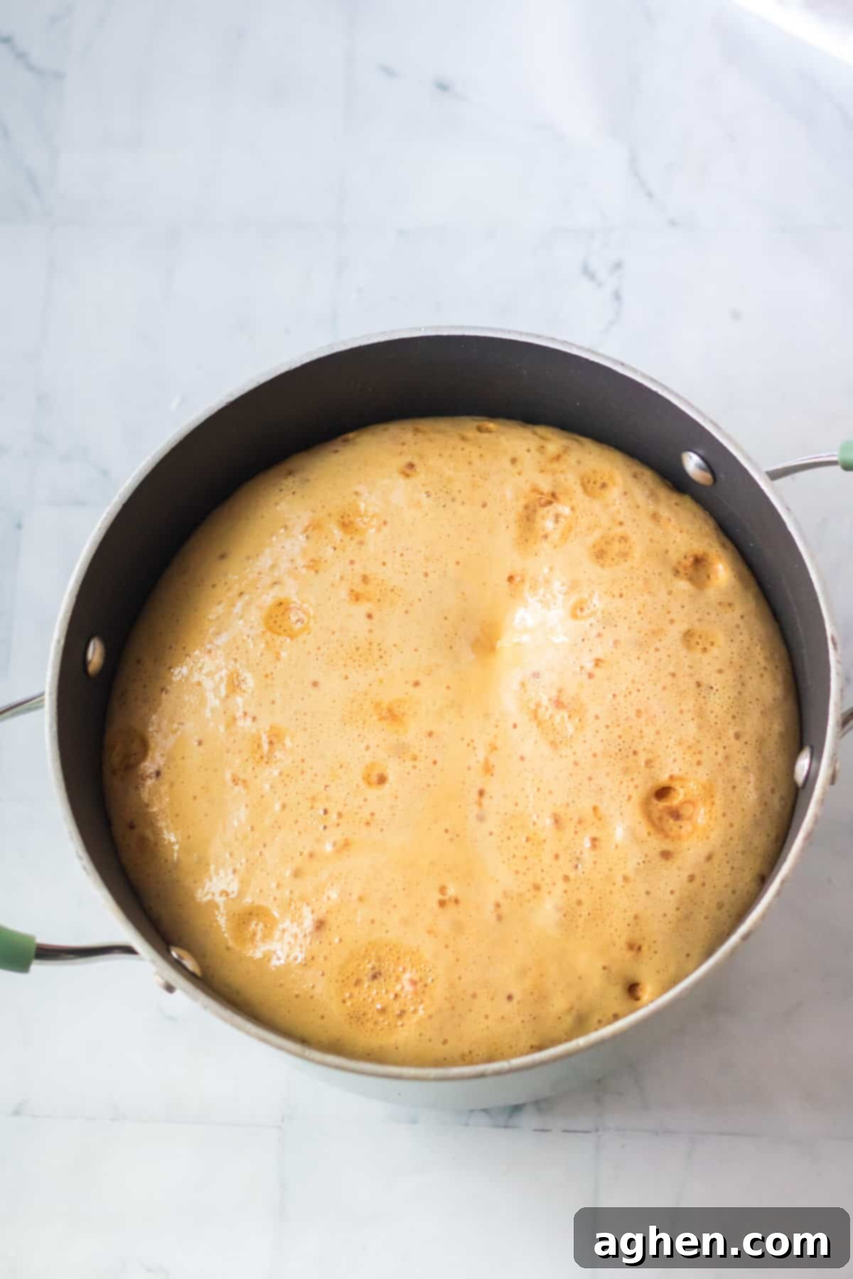 Honeycomb mixture tripling in size when baking soda is mixed in.
