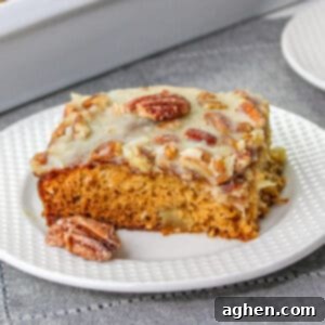 Slice of fruit cocktail cake topped with pecan coconut frosting.