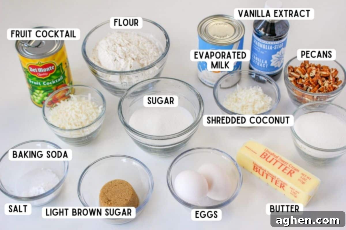 A collection of ingredients neatly arranged for baking a fruit cocktail cake, including flour, sugars, eggs, canned fruit cocktail, butter, and pecans.