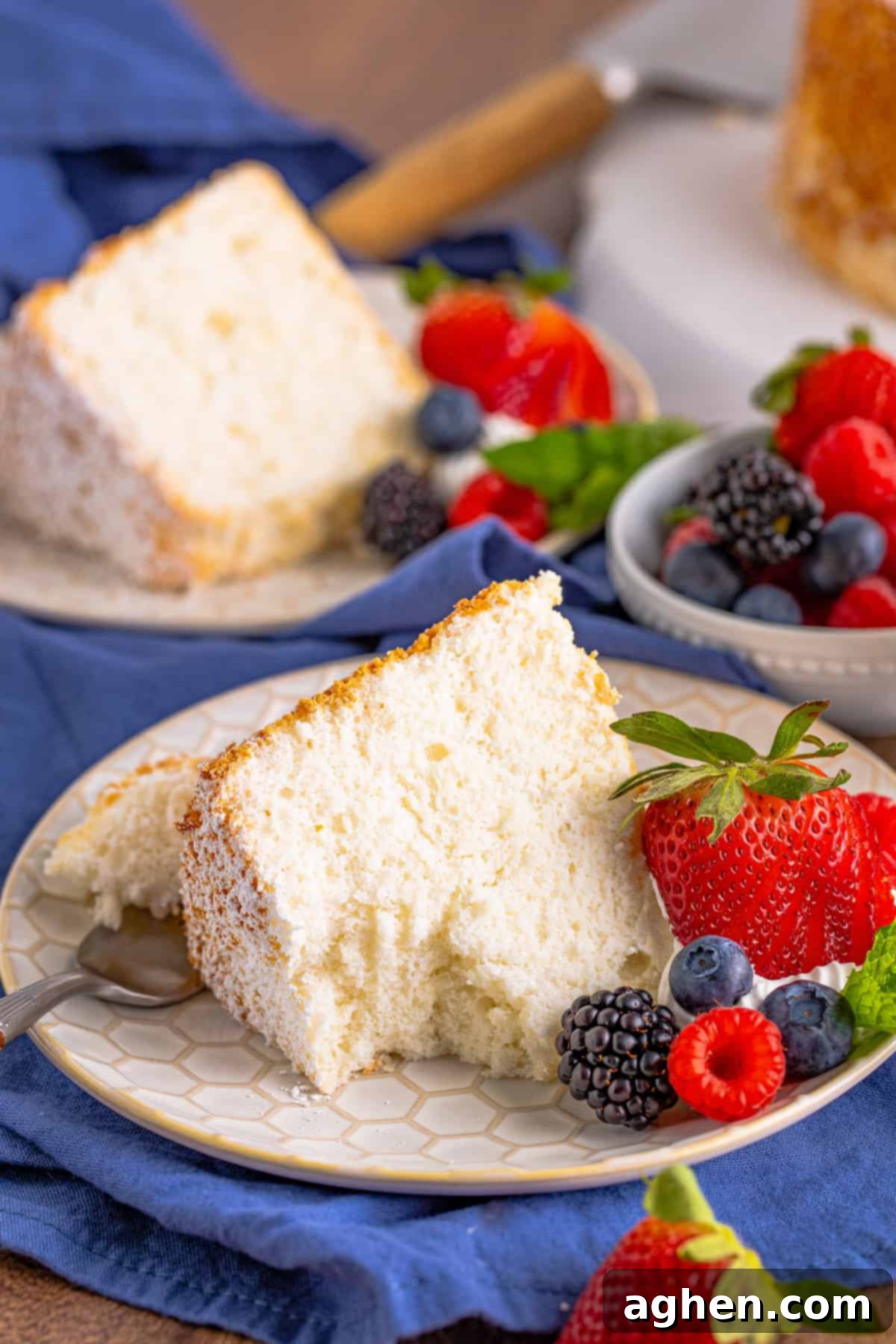Slice of light and fluffy angel food cake with a forkful removed.