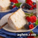 Angel food cake slice served with fresh berries.