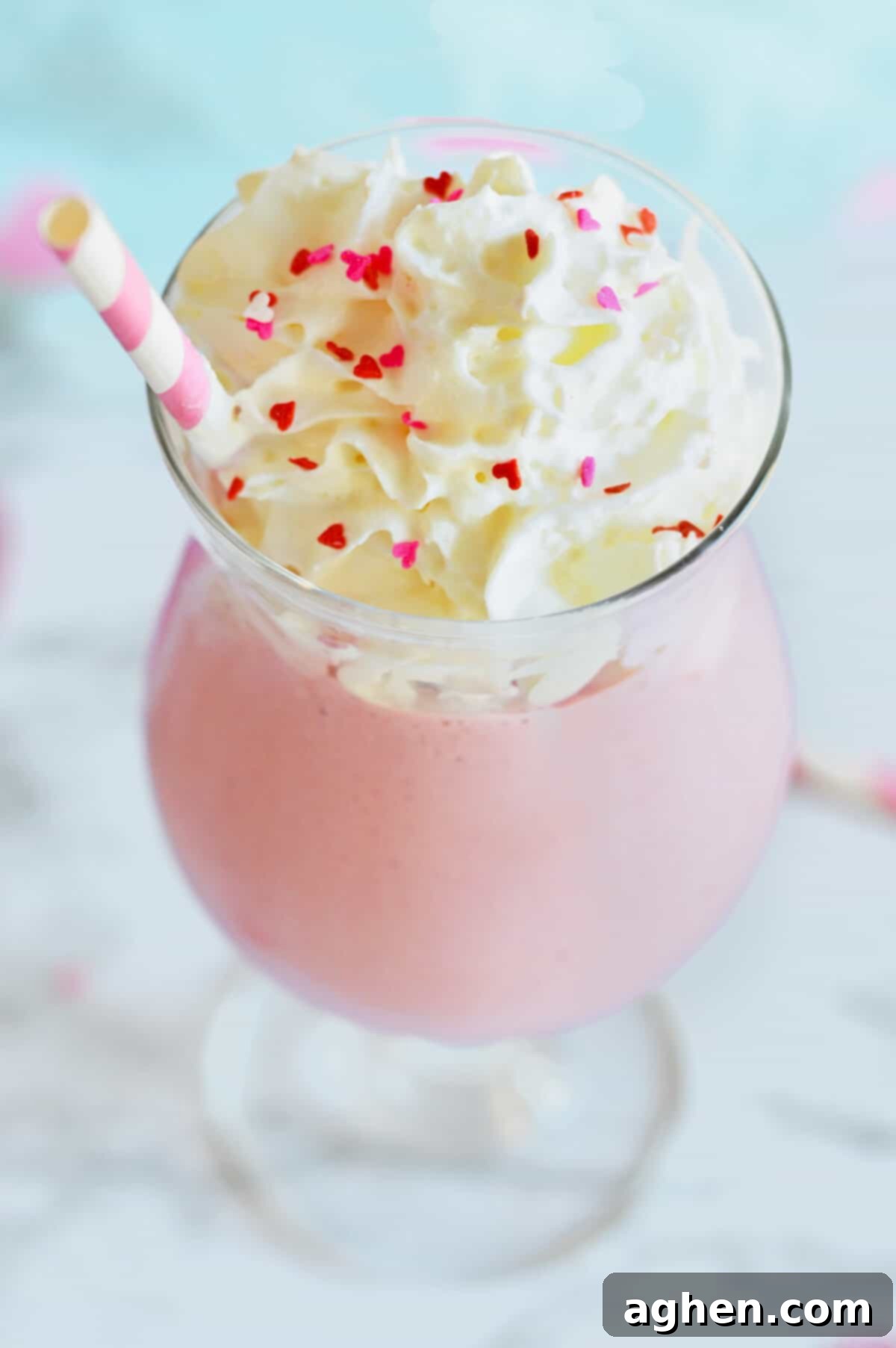 Strawberry mudslide drink topped with whipped cream and heart sprinkles.