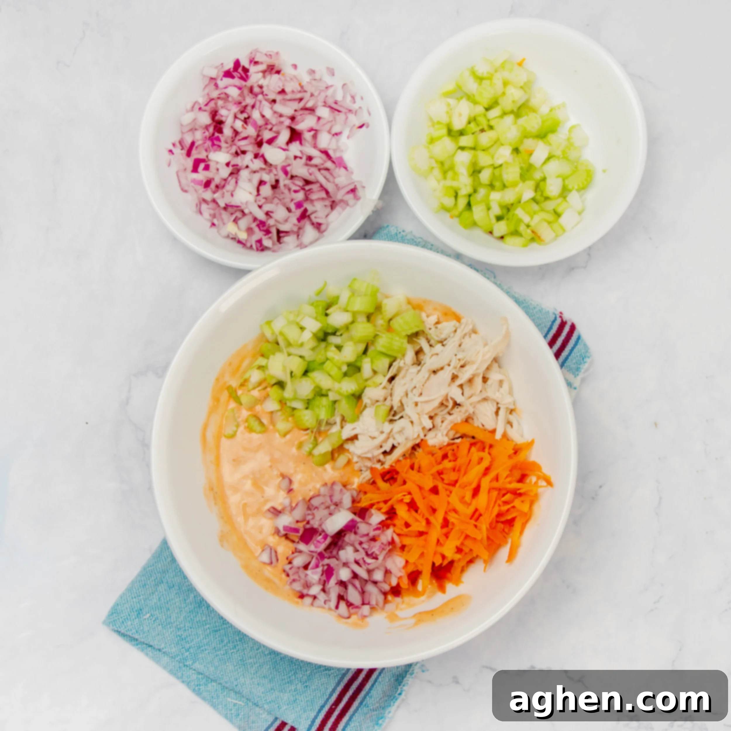 Deliciously Diet-Friendly Weight Watchers Buffalo Chicken Salad 5 Add the chopped salad ingredients to the bowl of dressing, including shredded chicken, celery, and red onion.