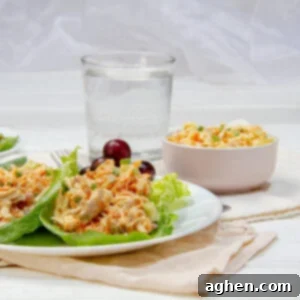 Deliciously Diet-Friendly Weight Watchers Buffalo Chicken Salad 7 Rich and creamy Buffalo Chicken Salad on a plate over lettuce wraps with water on the side.
