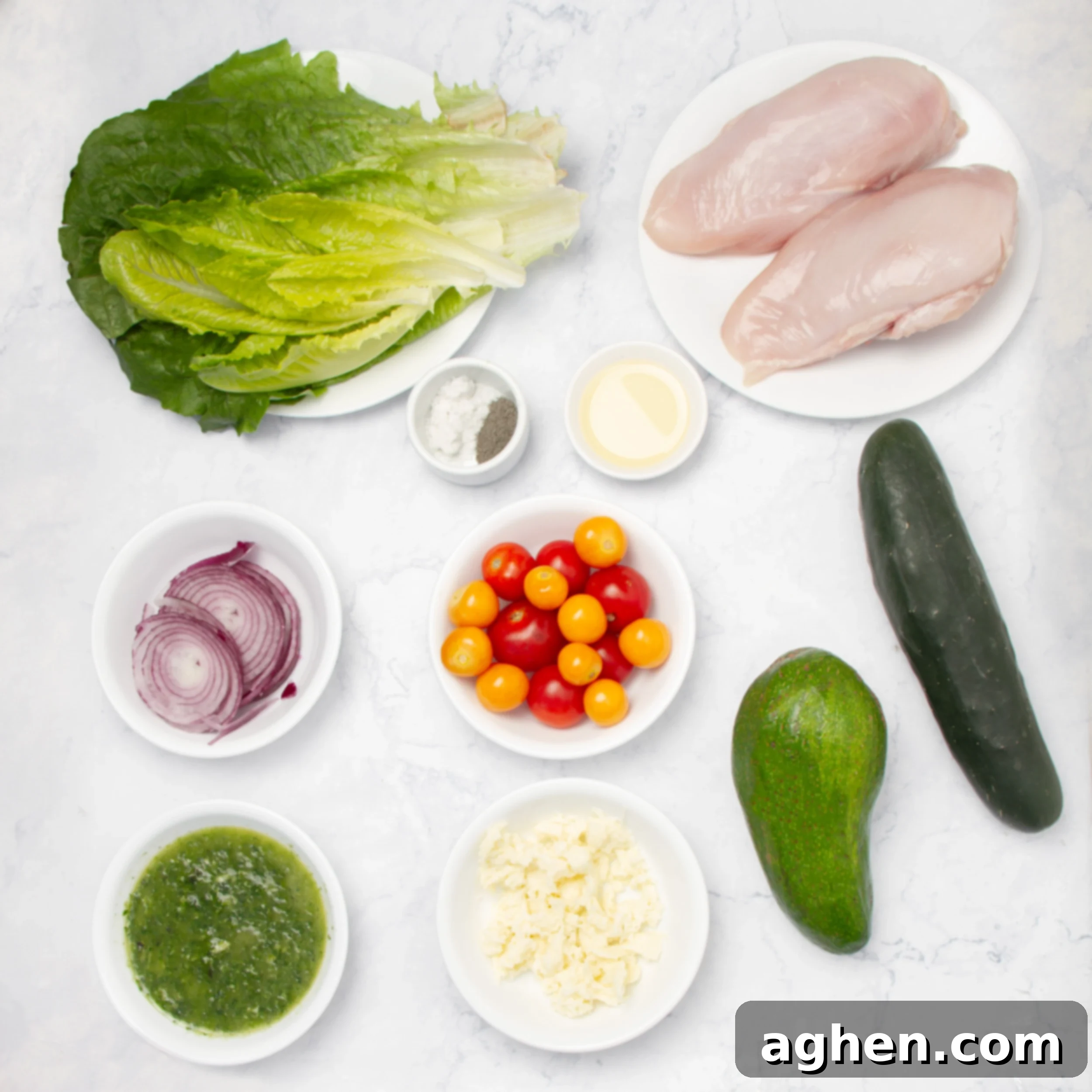 Pesto Chicken with Creamy Avocado 3 Fresh and vibrant Pesto Chicken and Avocado ingredients in separate dishes on a counter.