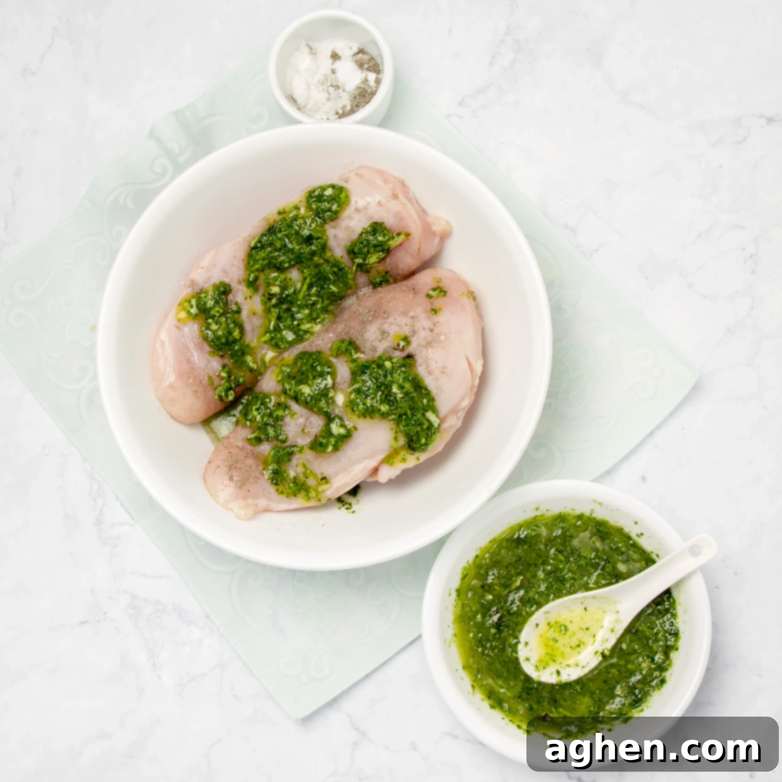 Pesto Chicken with Creamy Avocado 4 Chicken marinating in pesto sauce in a dish.