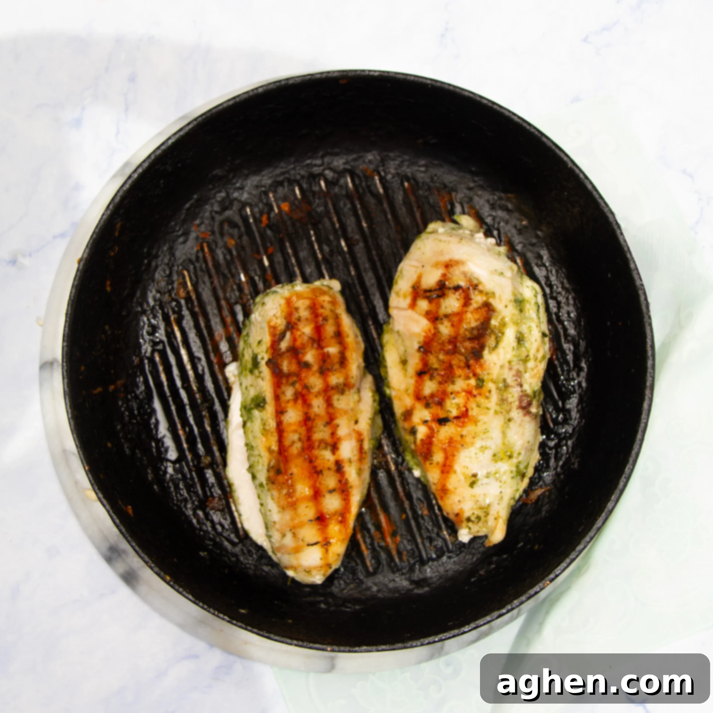 Pesto Chicken with Creamy Avocado 5 Chicken breasts browning on a grill.