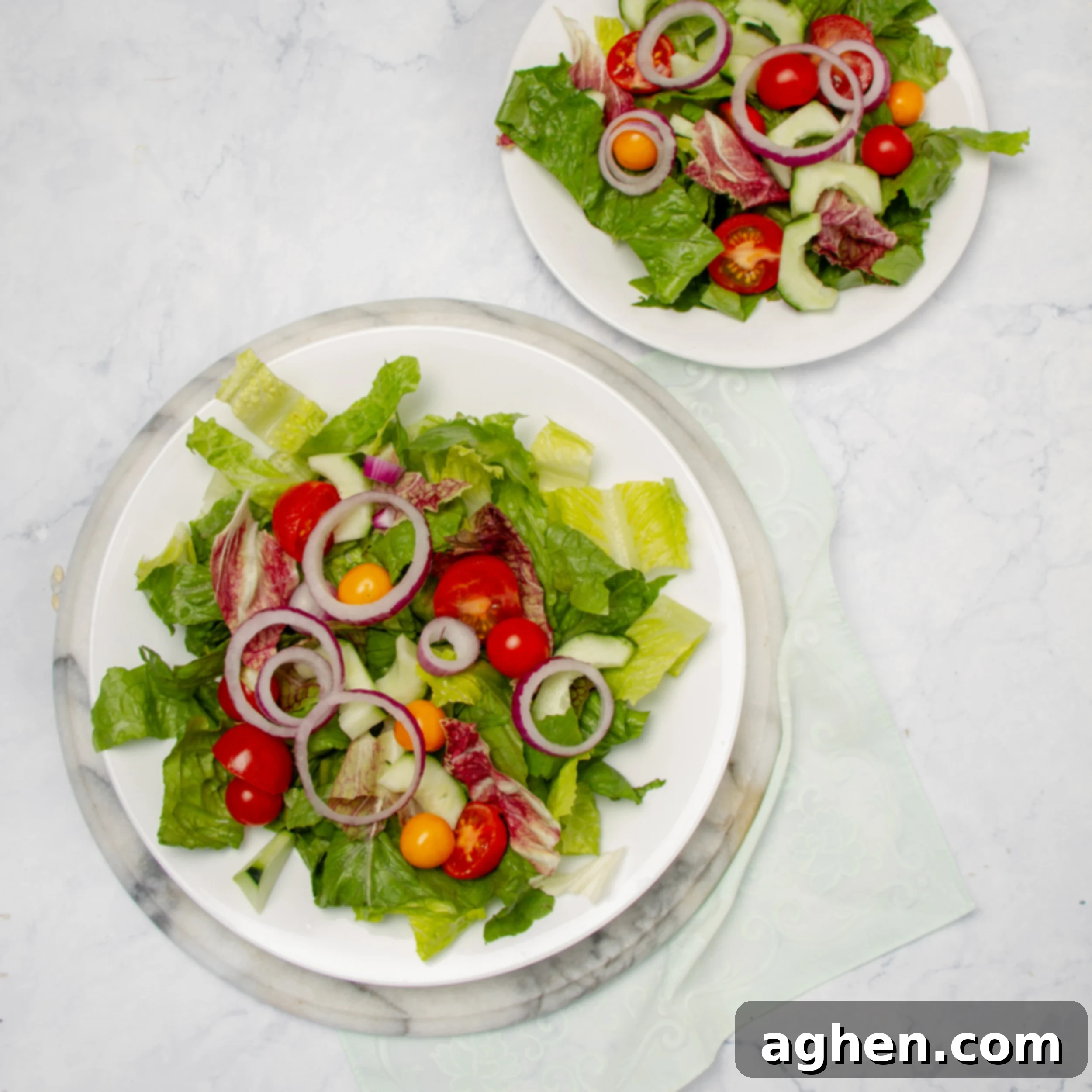 Pesto Chicken with Creamy Avocado 6 Salad base assembled on two small plates.