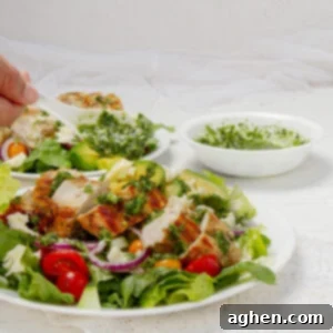 Pesto Chicken with Creamy Avocado 8 Healthy and vibrant Pesto Chicken and Avocado on a plate.
