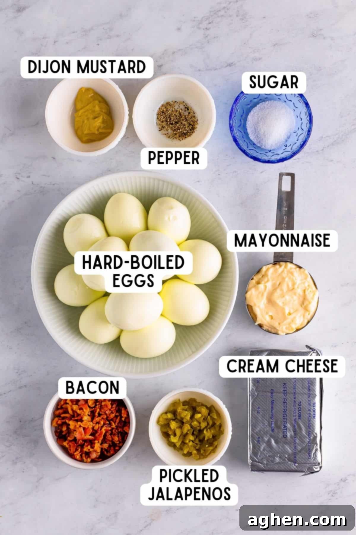 Fiery Deviled Egg Poppers 4 A flat lay photograph showcasing all the fresh ingredients needed to make Jalapeno Popper Deviled Eggs, including eggs, bacon, cream cheese, and pickled jalapenos.