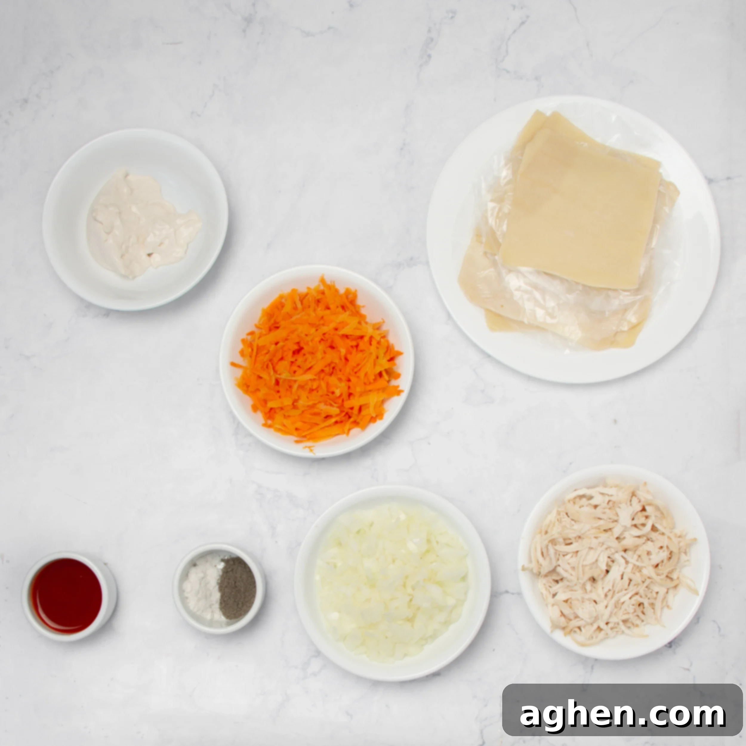 Buffalo Chicken Egg Roll ingredients in separate dishes on a counter. 