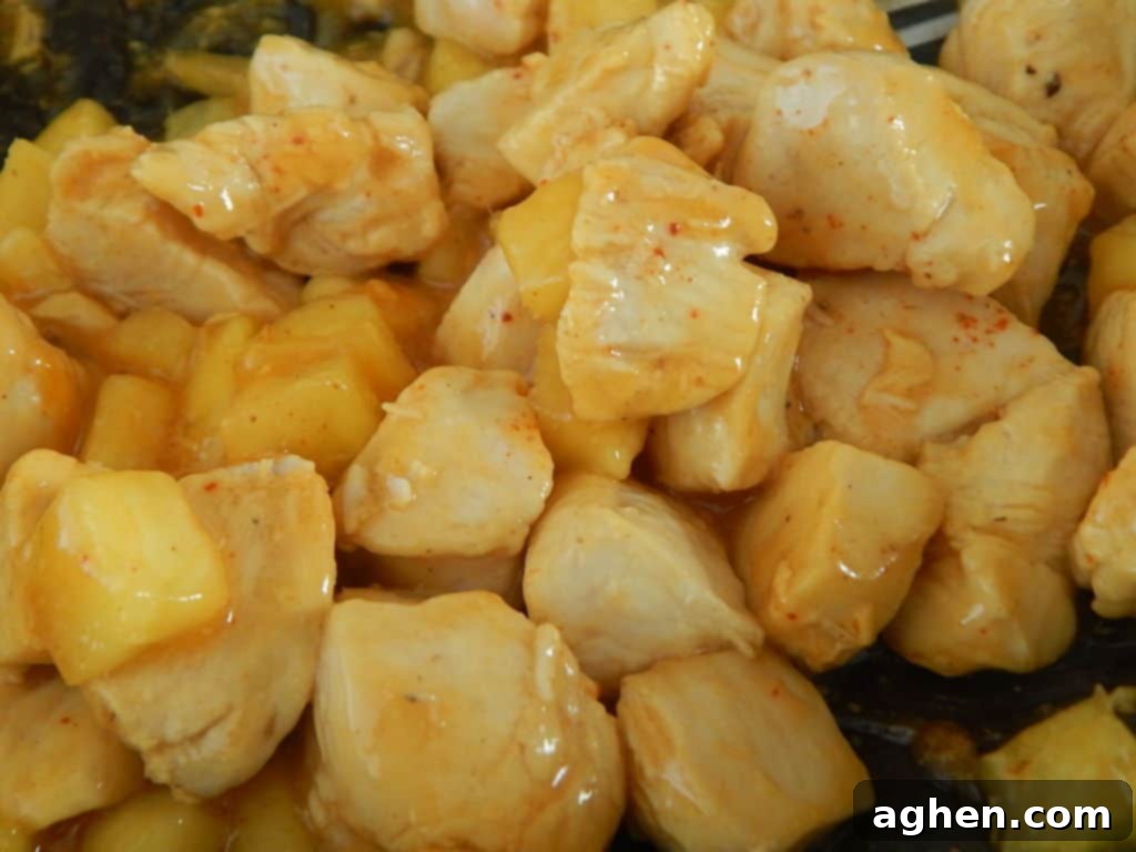 Fresh pineapple chunks added to chicken mixture