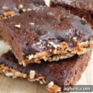 A close-up shot of the top of a Sea Salt Caramel Pretzel Brownie, featuring a visible pretzel crunch and caramel swirl.