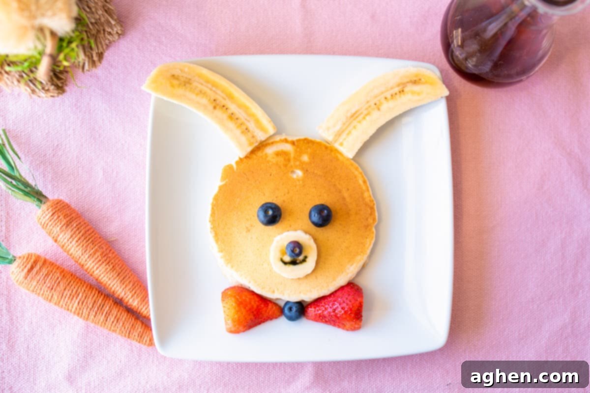 Bunny pancakes decorated with bananas and berries.