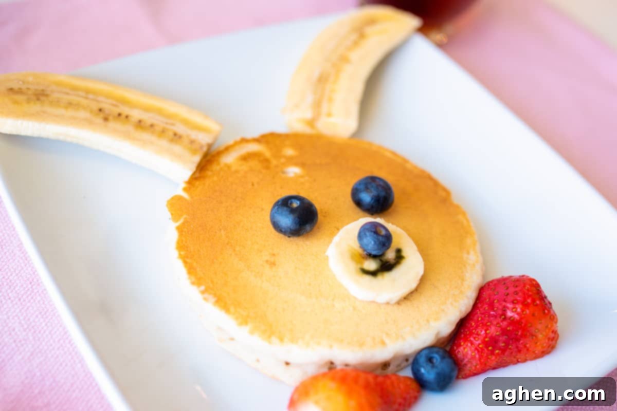 Pancake decorated with fresh fruit to look like a bunny rabbit.