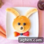 Bunny pancakes decorated with bananas and berries.