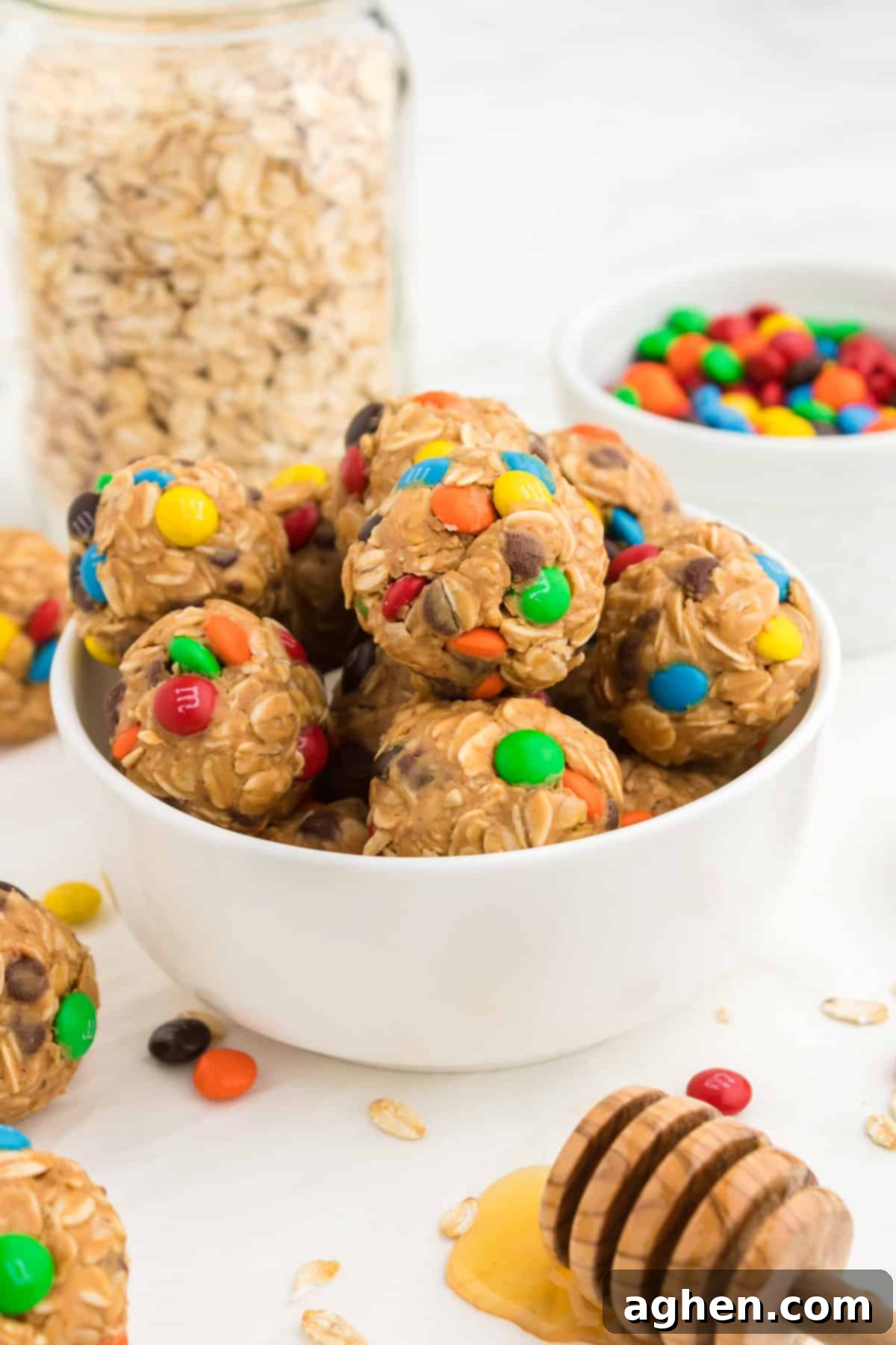 Delicious no-bake monster energy balls made with oats, mini M&M's, chocolate chips, peanut butter, and honey, perfect for a quick snack.