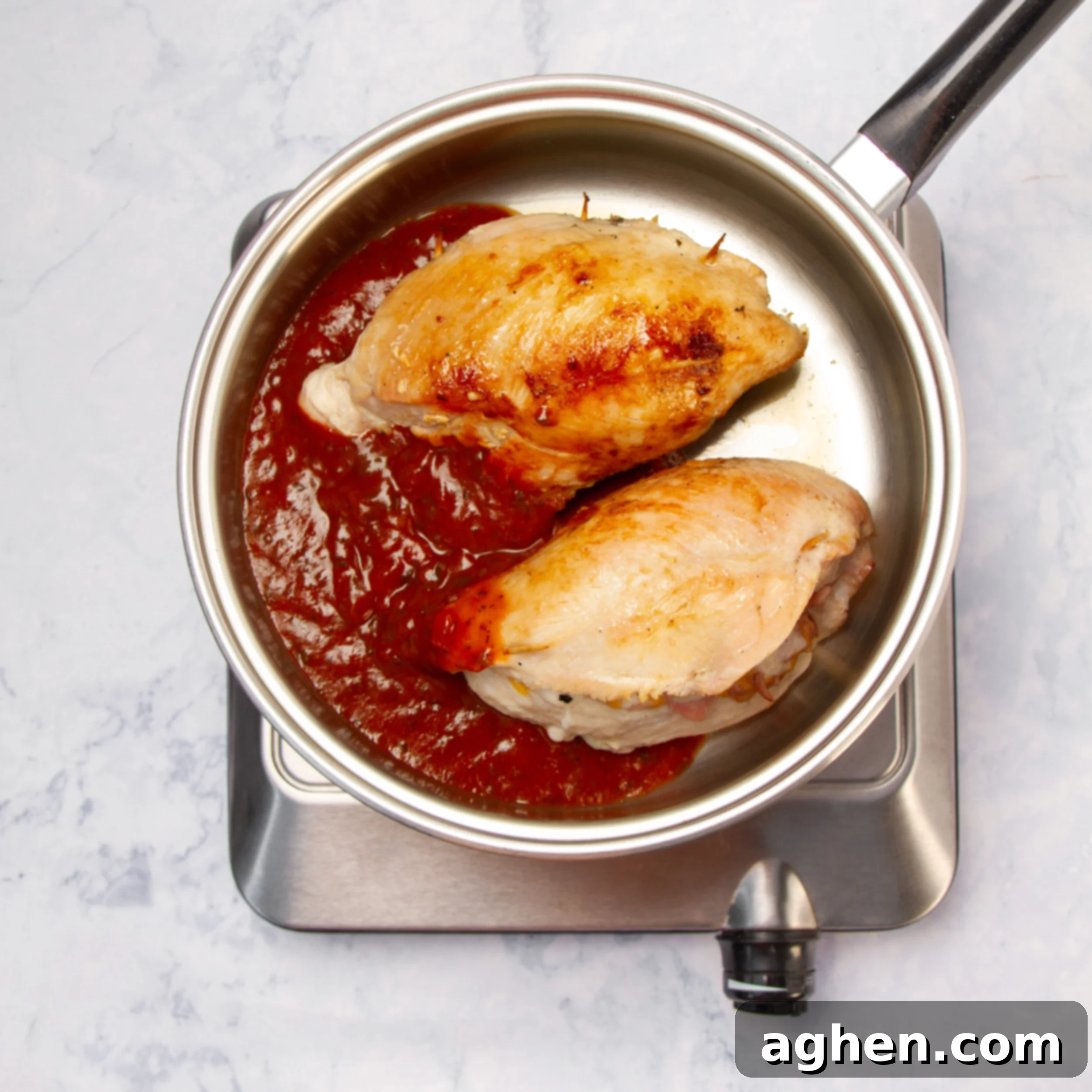 Elegant Stuffed Chicken Breast 6 Sauce added to the pan with cooked chicken breasts.