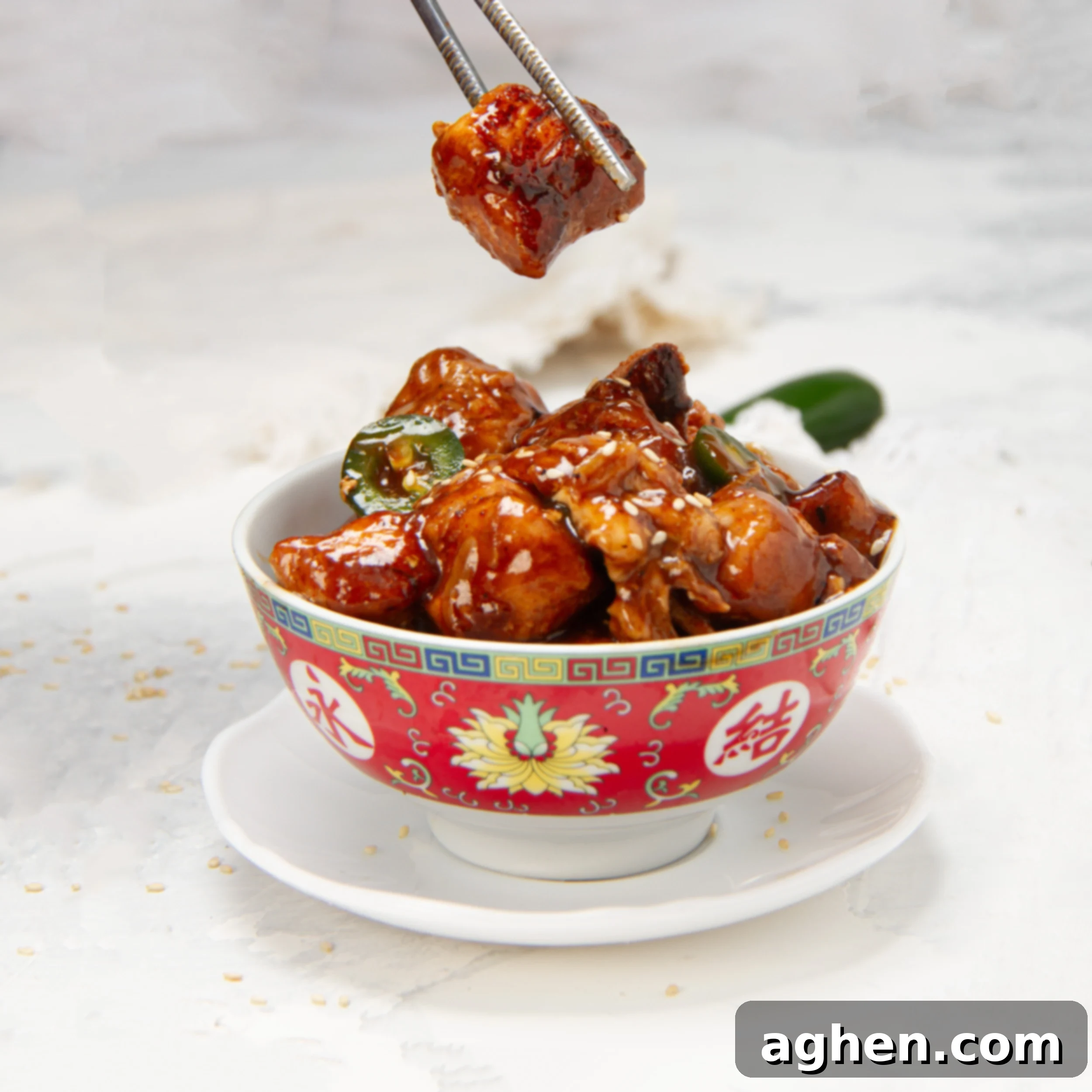 Healthy general Tso's chicken in a bowl with sesame seed garnish.