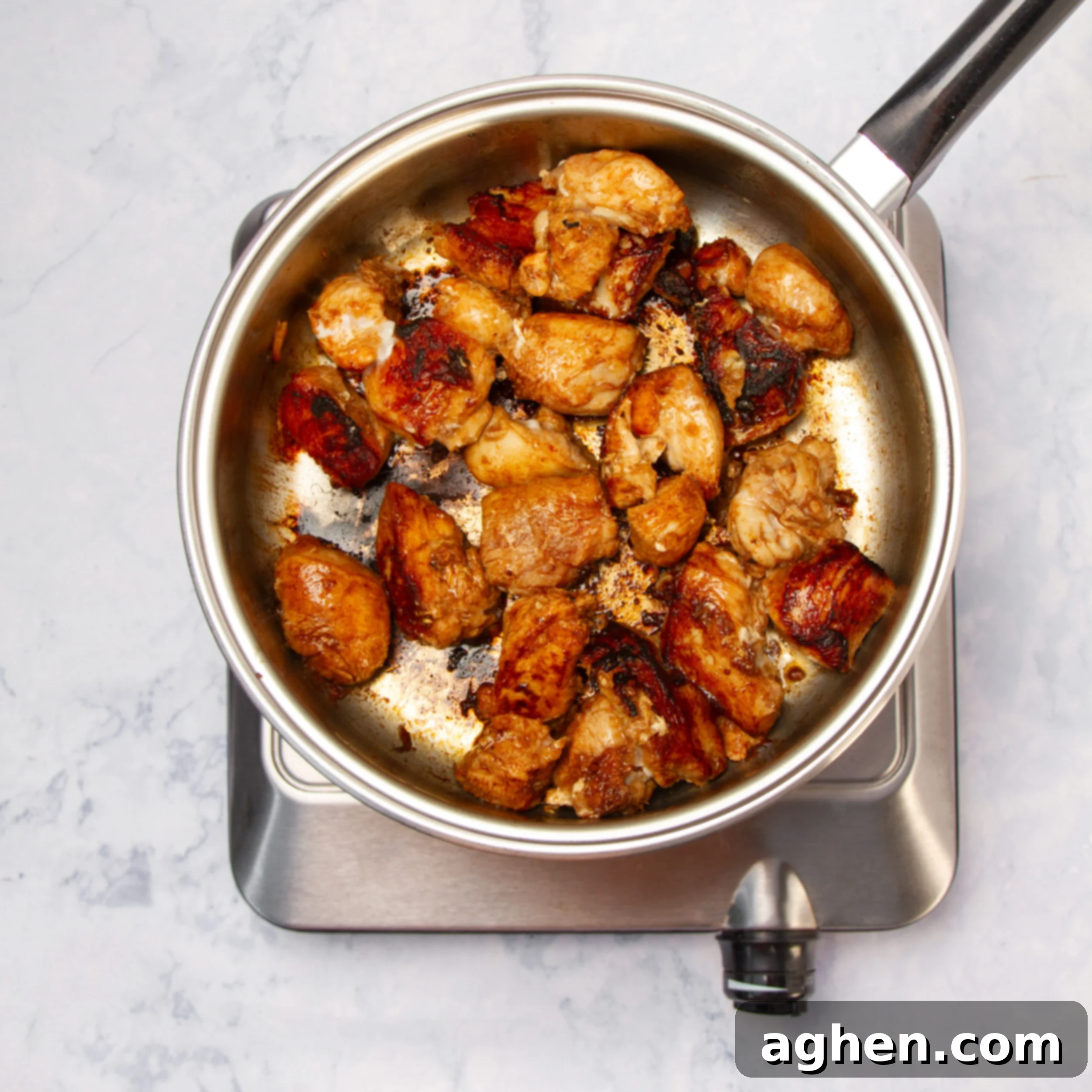 Marinated chicken cooking in a hot pan. 