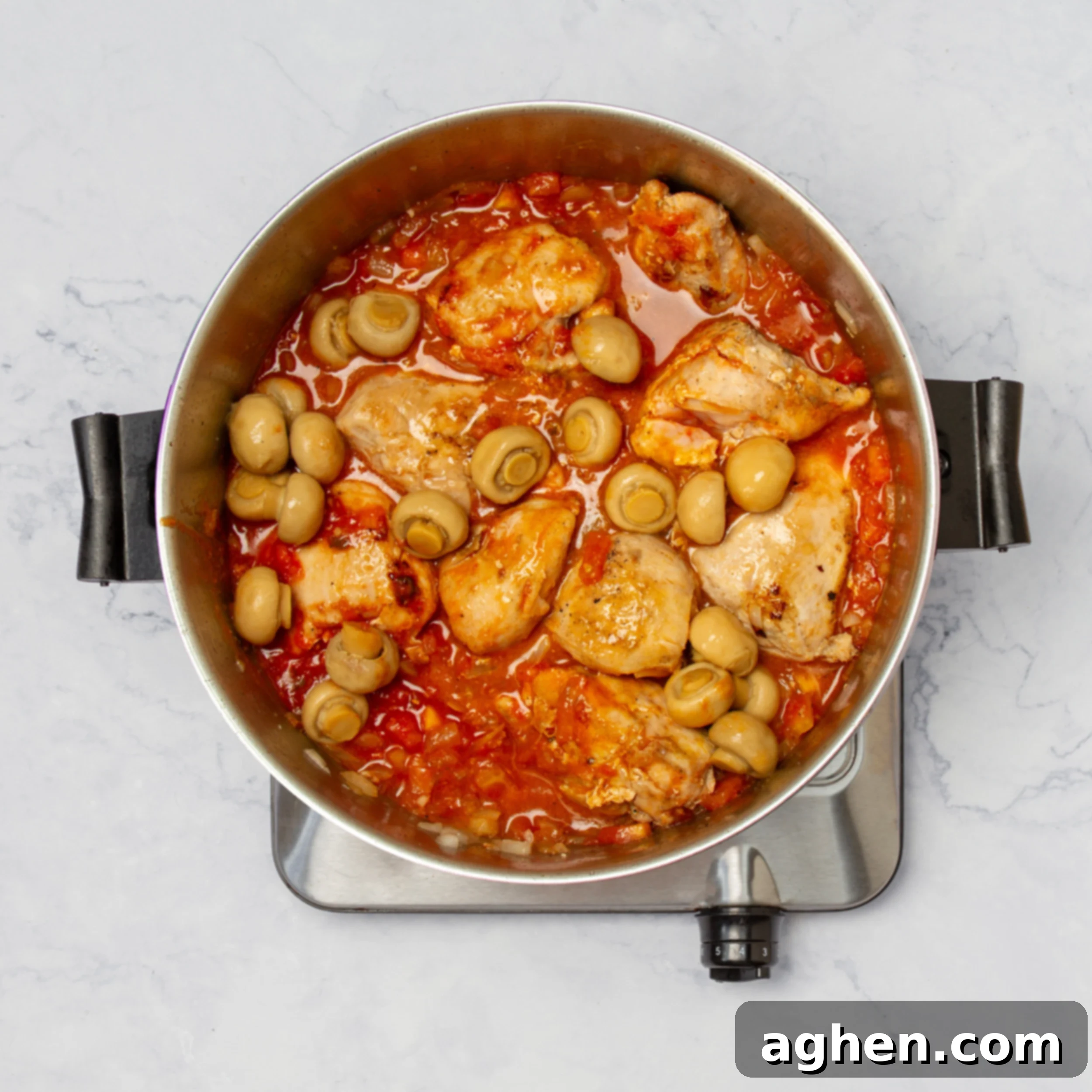 Napoleonic Chicken 7 All the cooked components—seared chicken, sautéed vegetables, savory orange-tomato sauce, and whole mushrooms—beautifully combined and simmering in a deep skillet, creating the complete and delicious Weight Watchers Chicken Marengo.