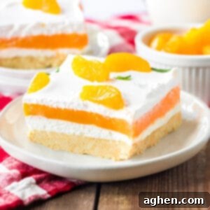 Velvet Orange Dream 10 Orange creamsicle lush with layers of creamy vanilla pudding and orange jello, sweetened cream cheese, and cool whip on a sweet cookie crust. Mandarin orange pieces top the no bake cake.
