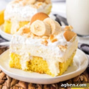 Banana Cream Dream Poke Cake 12 A tantalizing banana pudding poke cake, elegantly presented with fresh banana slices and crispy vanilla wafers on top, ready for serving.